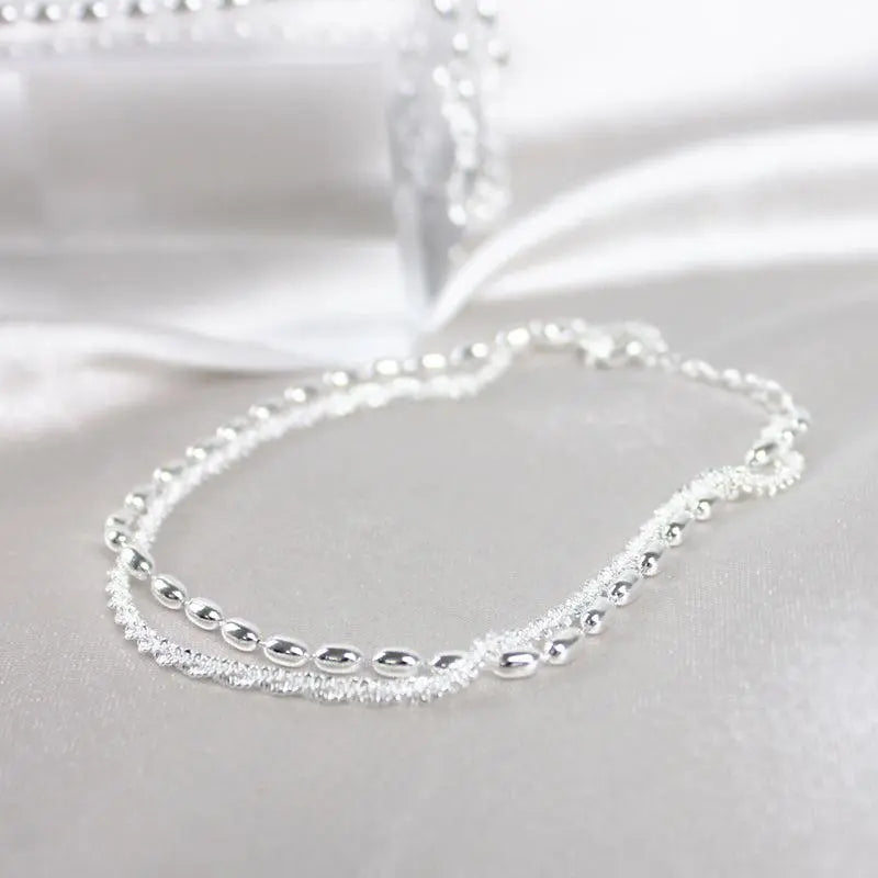 Elegantes Silberfarbenes Armband Set mit Zirkonia Steinen