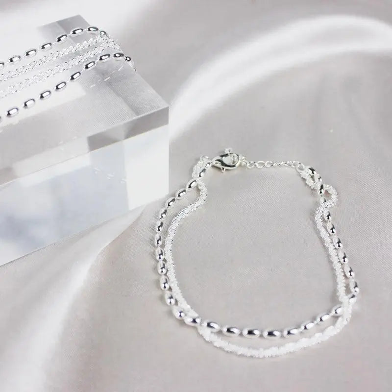 Elegantes Silberfarbenes Armband Set mit Zirkonia Steinen