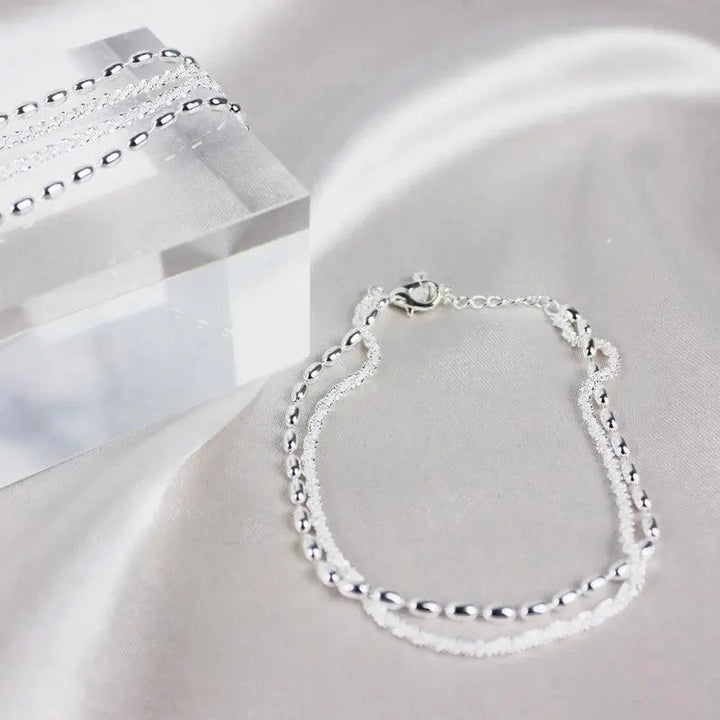 Elegantes Silberfarbenes Armband Set mit Zirkonia Steinen