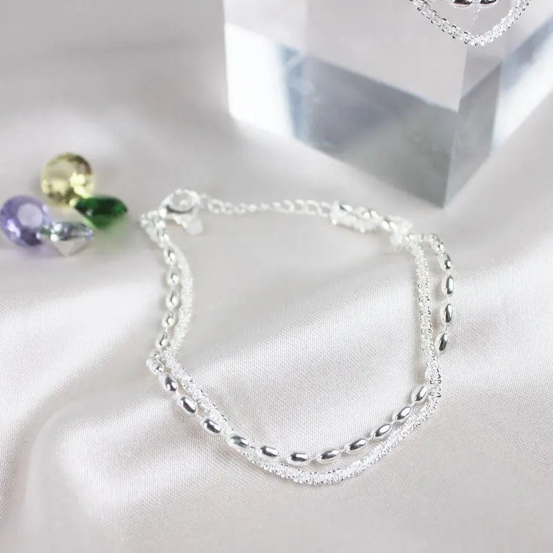 Elegantes Silberfarbenes Armband Set mit Zirkonia Steinen